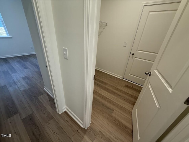 interior space with dark wood-type flooring and baseboards