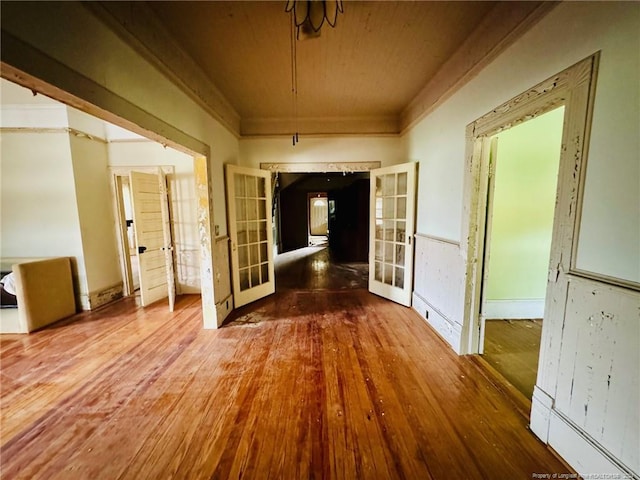 corridor featuring hardwood / wood-style floors and french doors