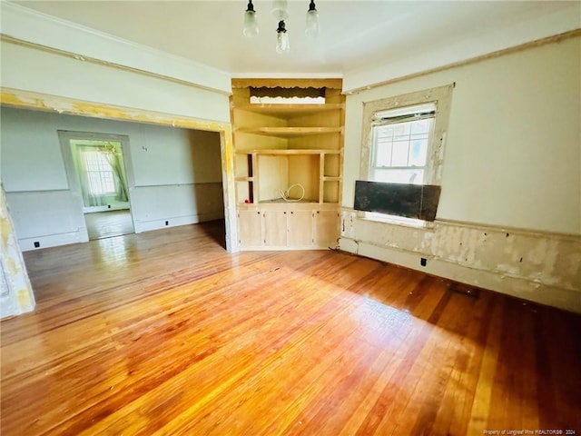 unfurnished living room featuring wood-type flooring and plenty of natural light