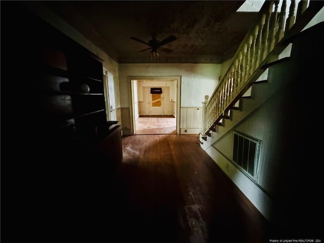 corridor with hardwood / wood-style flooring