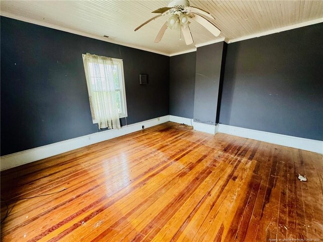 spare room with ceiling fan, crown molding, and wood-type flooring