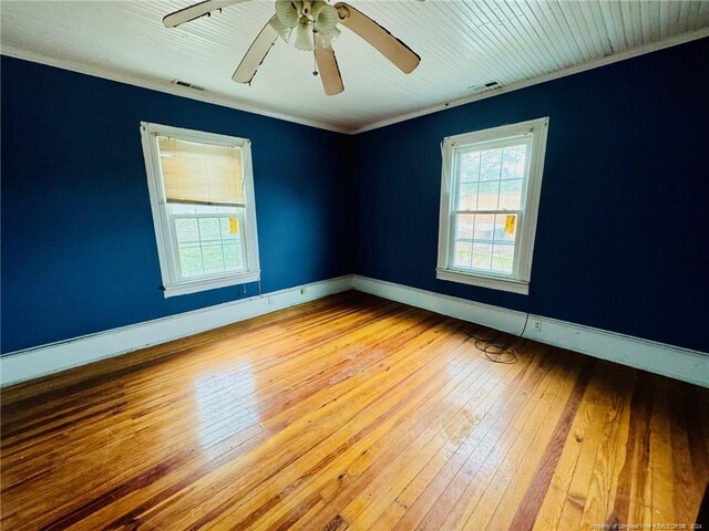 empty room with ornamental molding, ceiling fan, and hardwood / wood-style flooring