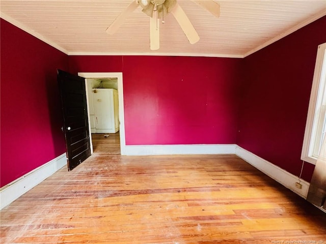 empty room featuring ornamental molding, ceiling fan, and hardwood / wood-style flooring