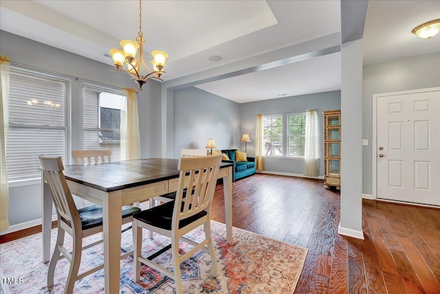 dining space featuring an inviting chandelier and dark wood-type flooring