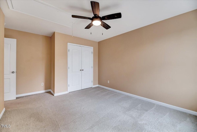 unfurnished bedroom with a closet, ceiling fan, and light colored carpet