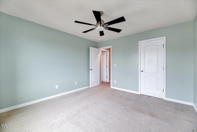 unfurnished bedroom featuring ceiling fan, a closet, and light carpet