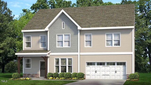 view of front of house with a front lawn and a garage