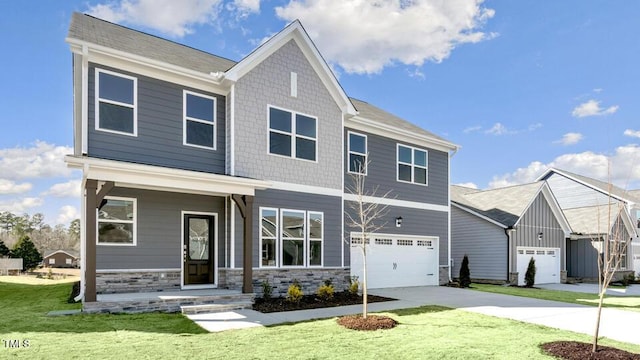 craftsman-style house with a front yard, stone siding, driveway, and an attached garage