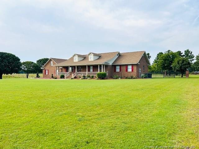 view of front of property with a porch and a front lawn