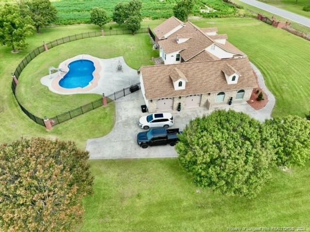 view of subject property with a pool