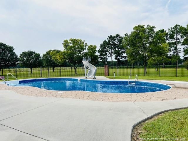 view of pool featuring a water slide and a patio area