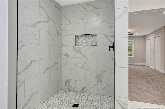 bathroom featuring tiled shower