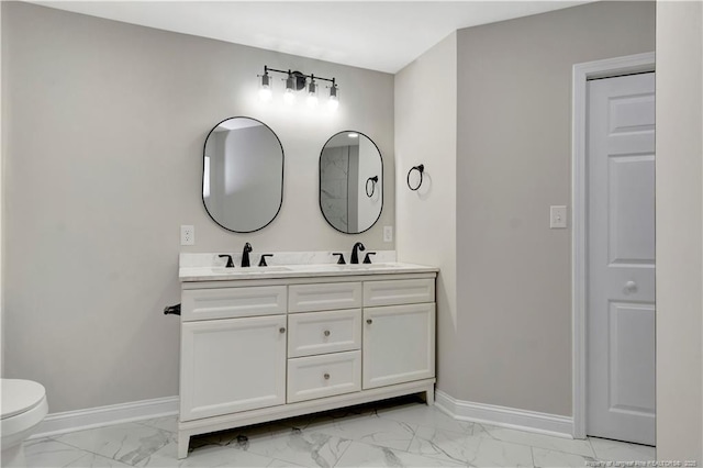 full bathroom featuring marble finish floor, baseboards, and a sink