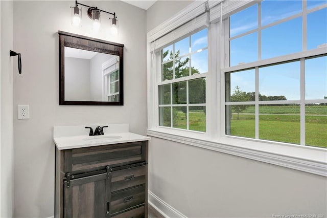 bathroom with baseboards and vanity