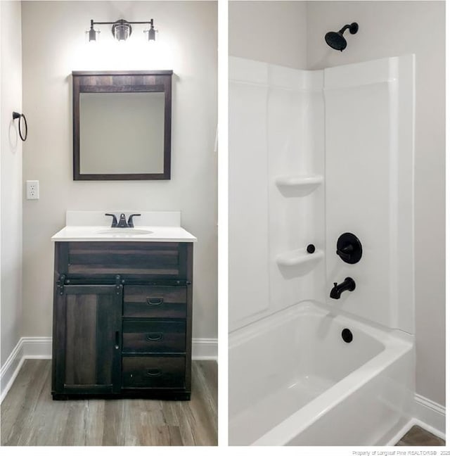 full bathroom with shower / bath combination, baseboards, wood finished floors, and vanity