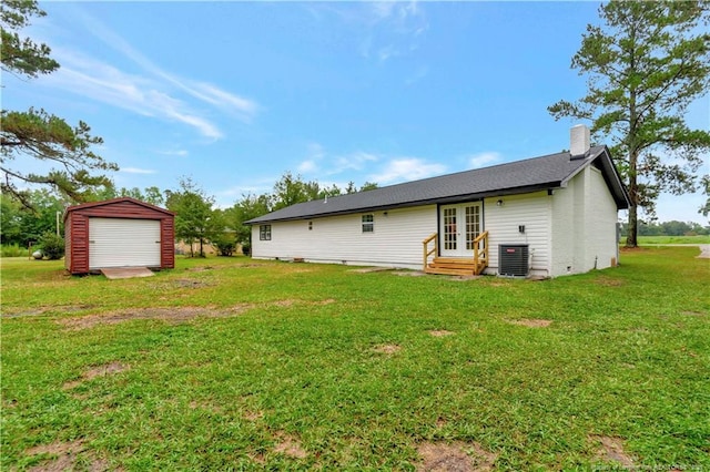 back of property featuring french doors, a yard, a chimney, central air condition unit, and entry steps