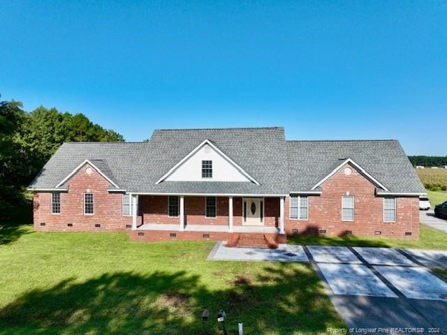 view of front of home featuring a front yard and covered porch