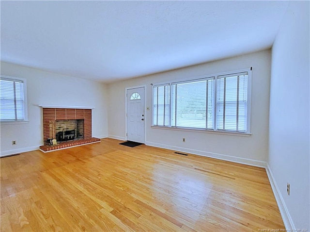 unfurnished living room featuring light hardwood / wood-style floors and a fireplace