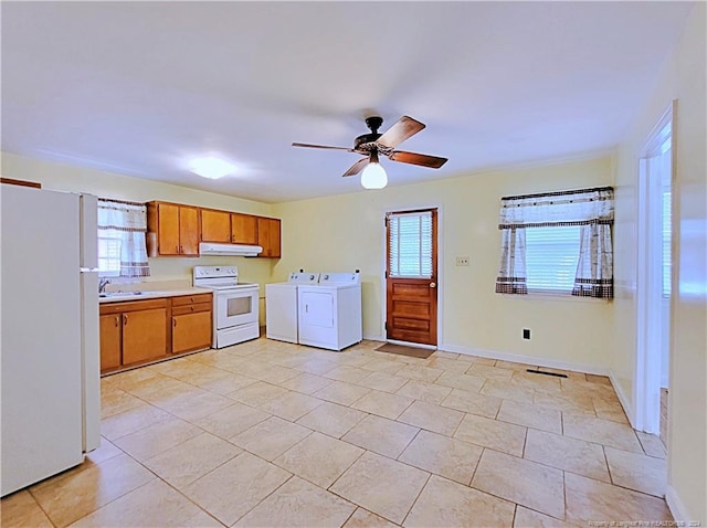 kitchen with ceiling fan, light tile patterned floors, sink, white appliances, and washer and clothes dryer