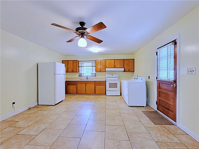 kitchen featuring ceiling fan, light tile patterned floors, sink, white appliances, and washer and dryer