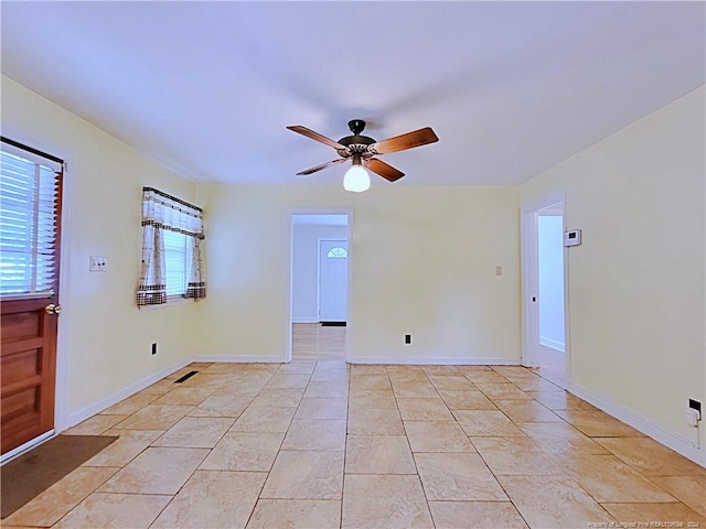 tiled empty room with ceiling fan