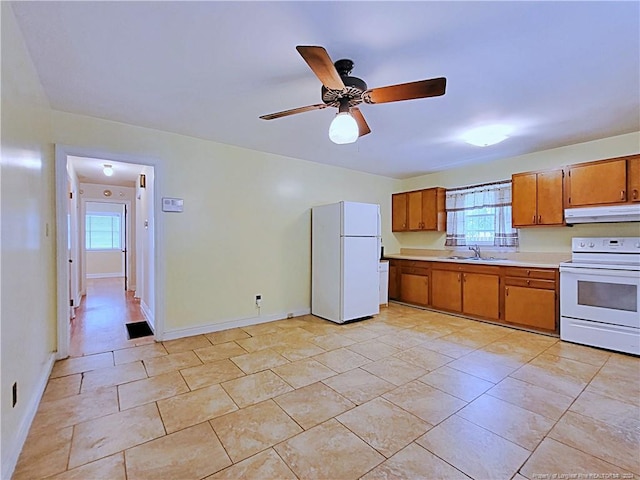 kitchen with range hood, white appliances, ceiling fan, and sink