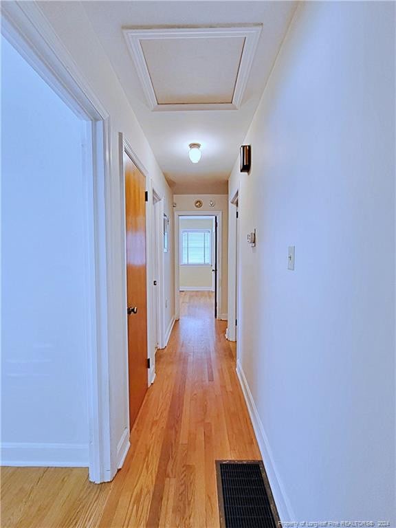 hallway with light hardwood / wood-style floors