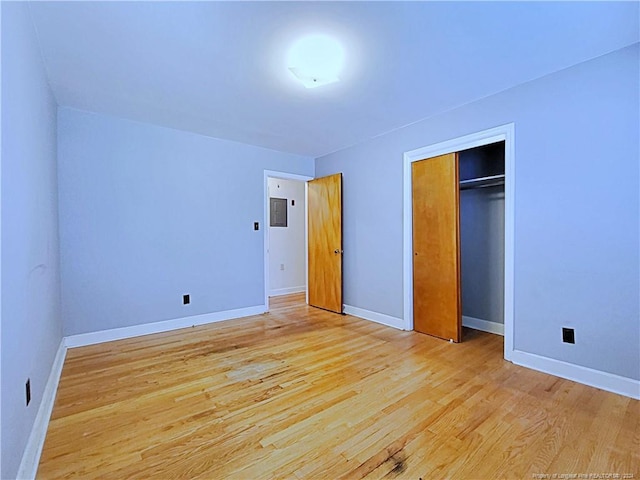 unfurnished bedroom featuring light hardwood / wood-style flooring and a closet