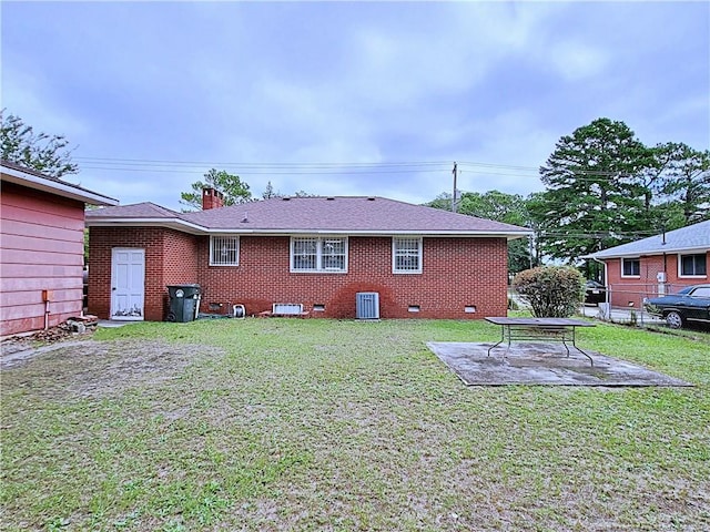 back of house with a lawn, a patio, and central AC unit