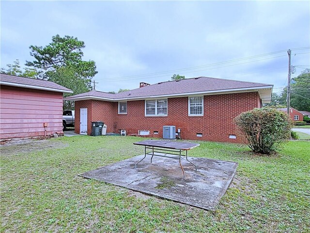 rear view of house with a lawn, a patio area, and central air condition unit