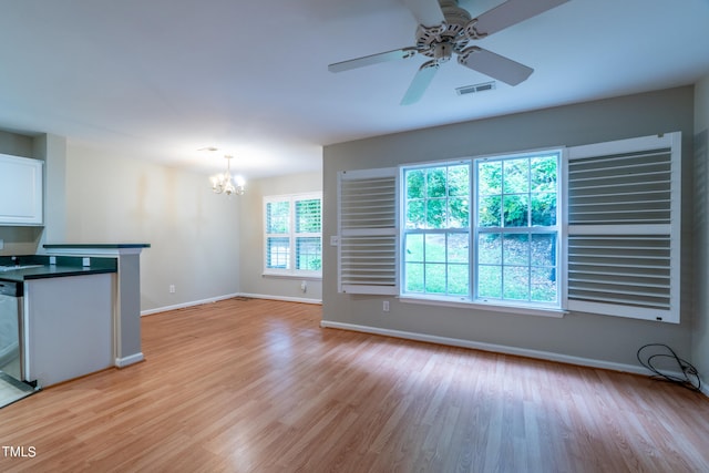 kitchen featuring light hardwood / wood-style floors, ceiling fan with notable chandelier, white cabinetry, hanging light fixtures, and stainless steel dishwasher