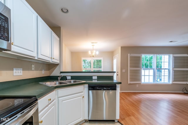 kitchen featuring white cabinets, a wealth of natural light, and appliances with stainless steel finishes