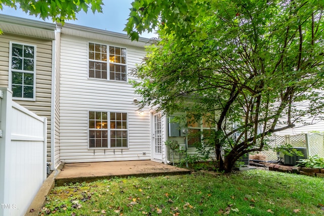 back of property featuring a yard and a patio area