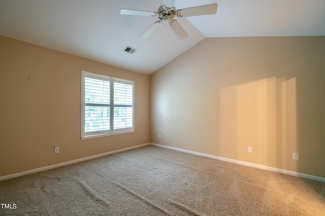 empty room with vaulted ceiling, ceiling fan, and light carpet