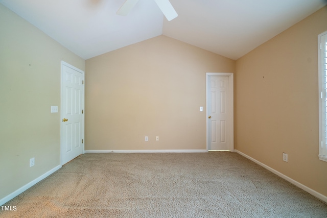 empty room with carpet, lofted ceiling, and ceiling fan