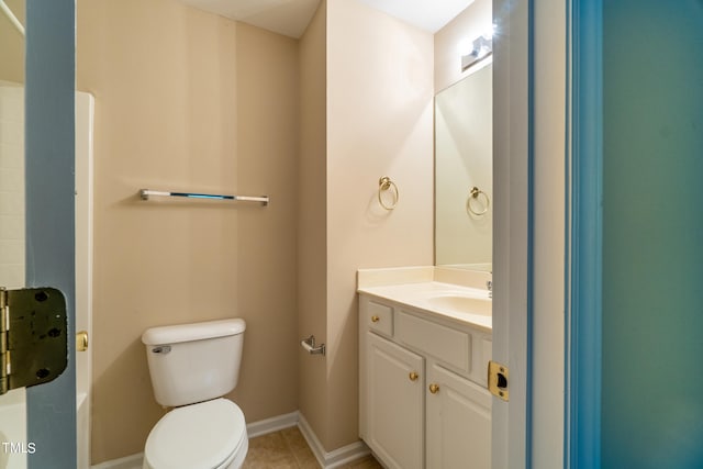 bathroom featuring tile patterned flooring, vanity, and toilet