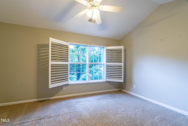 carpeted empty room featuring vaulted ceiling and ceiling fan