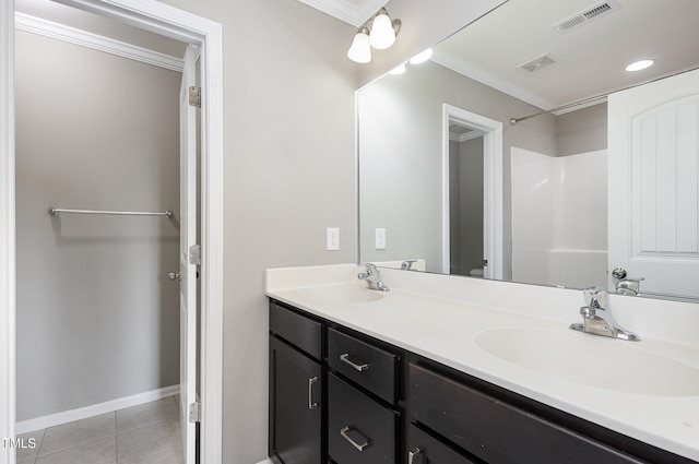 bathroom featuring vanity, walk in shower, tile patterned floors, ornamental molding, and toilet