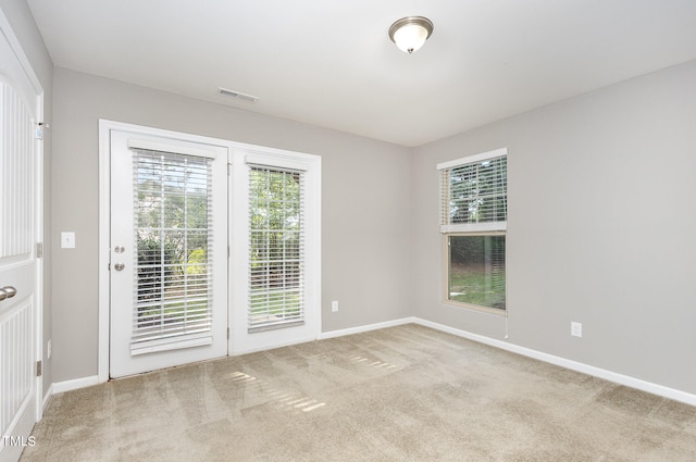 spare room with light carpet