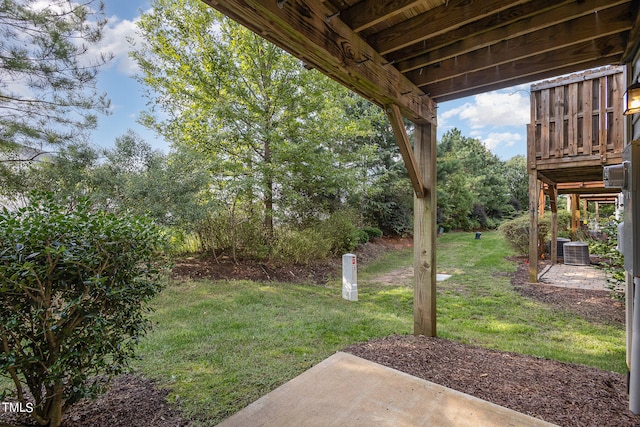 view of yard featuring cooling unit and a patio