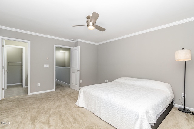 bedroom featuring ornamental molding, a spacious closet, ceiling fan, and light colored carpet