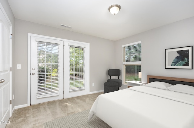 carpeted bedroom featuring access to exterior