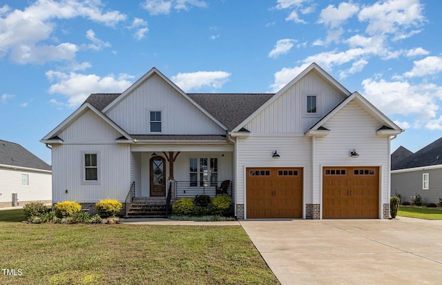 modern farmhouse style home featuring a front yard, a porch, and a garage