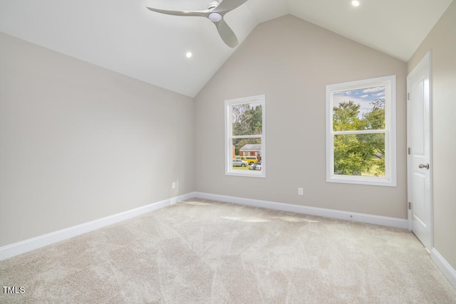 carpeted spare room with ceiling fan and lofted ceiling