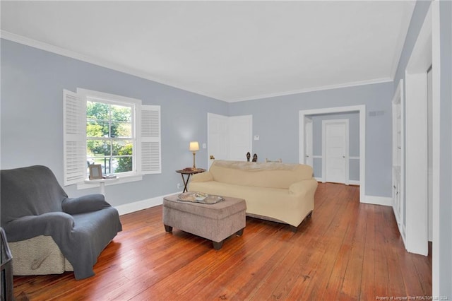 living room featuring wood-type flooring and crown molding