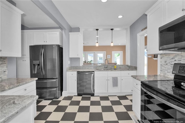 kitchen with white cabinets and appliances with stainless steel finishes