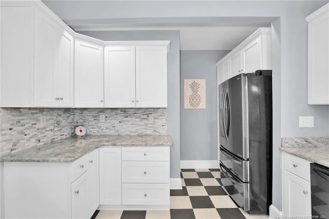 kitchen featuring white cabinets, stainless steel refrigerator, decorative backsplash, and black dishwasher