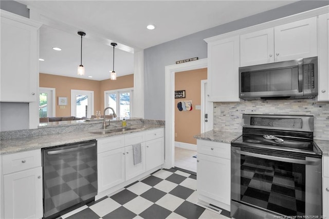 kitchen featuring backsplash, stainless steel appliances, white cabinetry, and sink