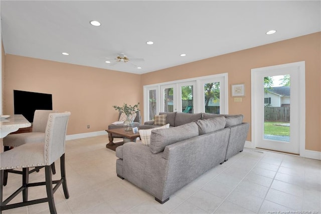 living room featuring light tile patterned floors, ceiling fan, and french doors