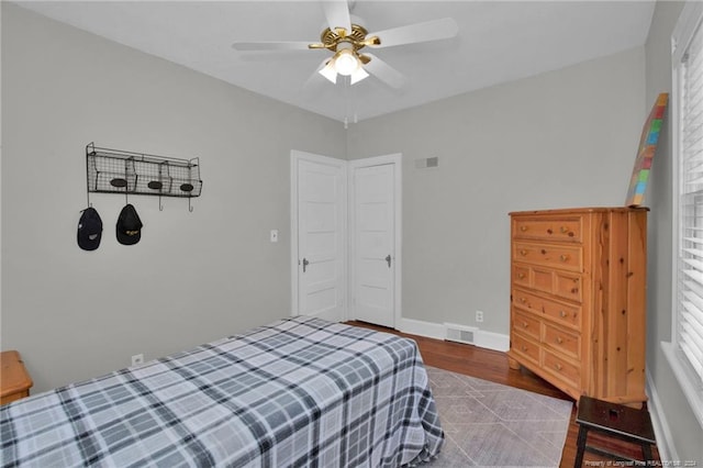 bedroom with ceiling fan and hardwood / wood-style floors